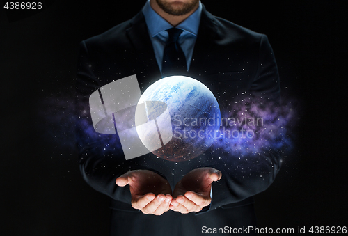 Image of close up of businessman with planet hologram