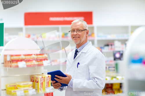 Image of senior with tablet pc at pharmacy