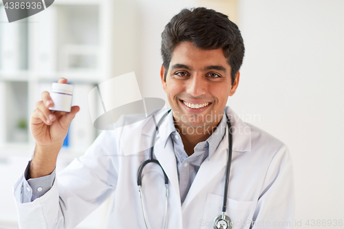 Image of happy doctor with stethoscope and medication