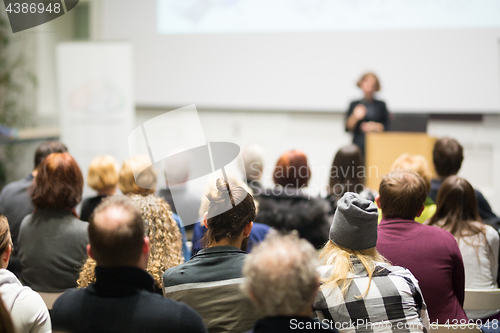 Image of Woman giving presentation in lecture hall at university.