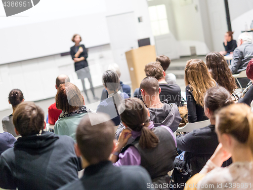 Image of Woman giving presentation in lecture hall at university.