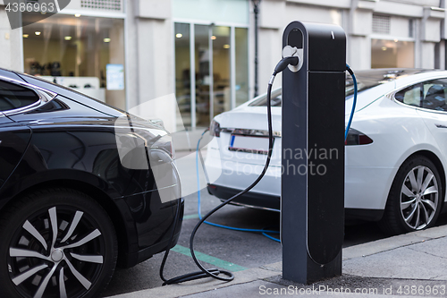Image of Charging modern electric car on the street as future of automotive industry.