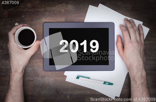 Image of Tablet touch computer gadget on wooden table - 2019