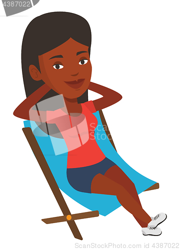 Image of Young woman sitting in folding chair.