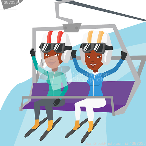 Image of Two happy skiers using cableway at ski resort.