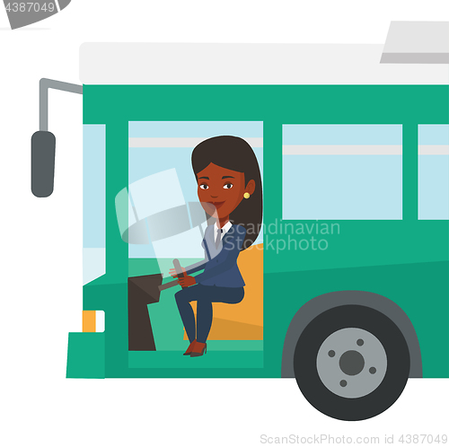 Image of African bus driver sitting at steering wheel.
