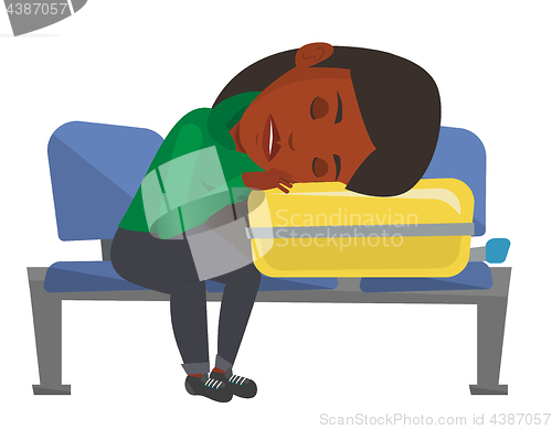 Image of Exhausted woman sleeping on suitcase at airport.