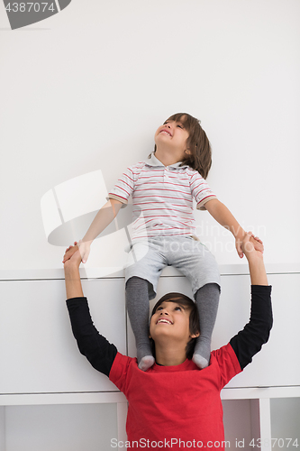 Image of young boys posing line up piggyback