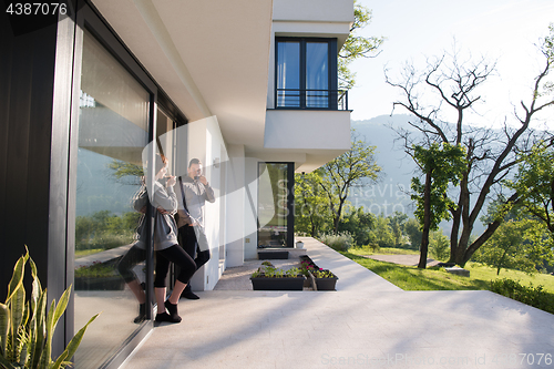 Image of couple enjoying on the door of their luxury home villa