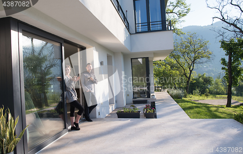 Image of couple enjoying on the door of their luxury home villa