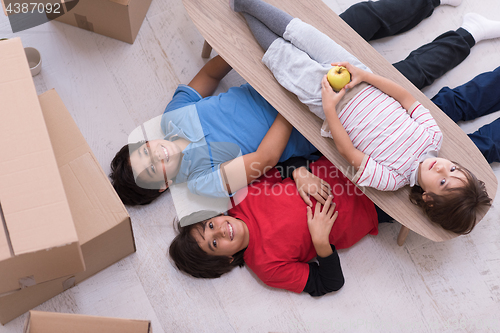 Image of boys with cardboard boxes around them top view