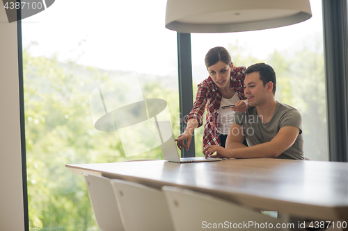 Image of happy young couple buying online