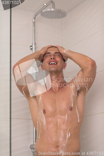 Image of man taking shower in bath