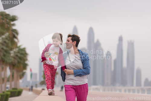 Image of mother and cute little girl on the promenade