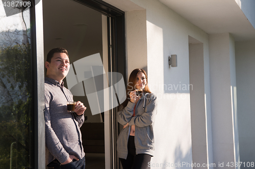 Image of couple enjoying on the door of their luxury home villa