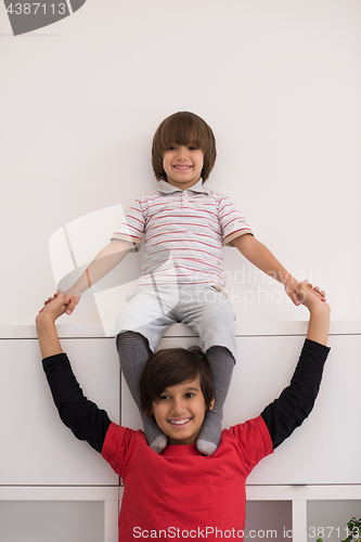 Image of young boys posing line up piggyback