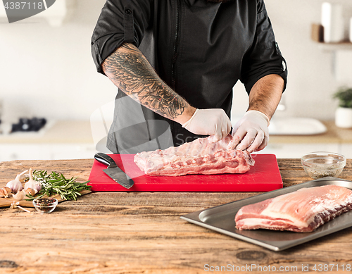 Image of Man cooking meat steak on kitchen