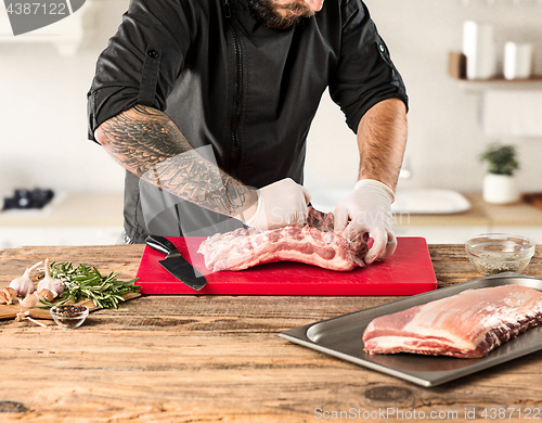 Image of Man cooking meat steak on kitchen