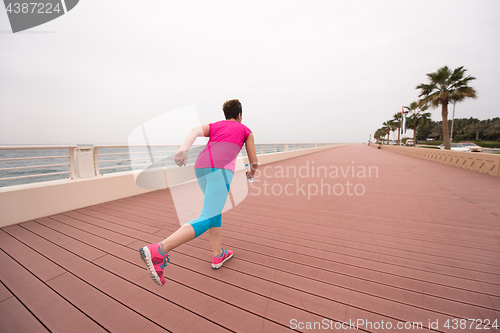 Image of woman busy running on the promenade