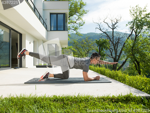 Image of man doing morning yoga exercises