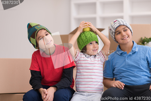 Image of boys with cardboard boxes around them