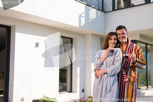 Image of Young beautiful couple in bathrobes