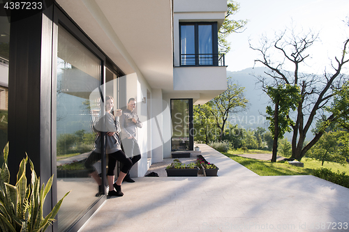 Image of couple enjoying on the door of their luxury home villa