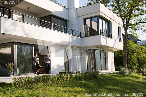 Image of couple enjoying on the door of their luxury home villa