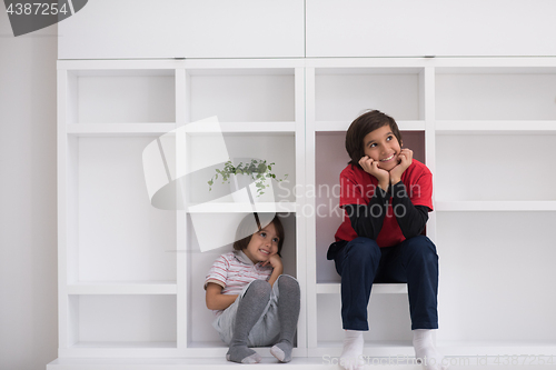 Image of young boys posing on a shelf