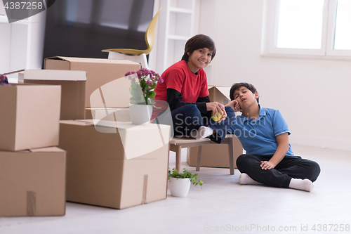 Image of boys with cardboard boxes around them