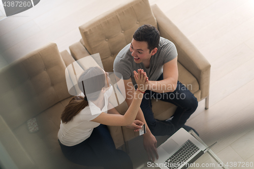 Image of happy young couple buying online