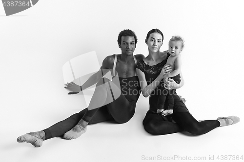 Image of A happy family of ballet dancers on white studio background