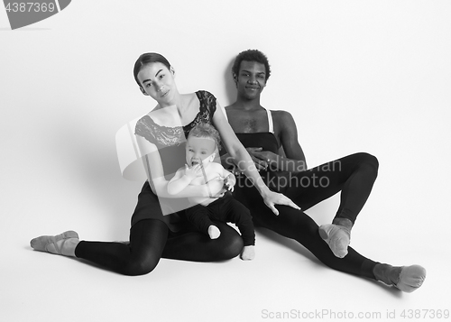 Image of A happy family of ballet dancers on white studio background