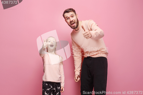 Image of Young father with his baby daughter with thumb up