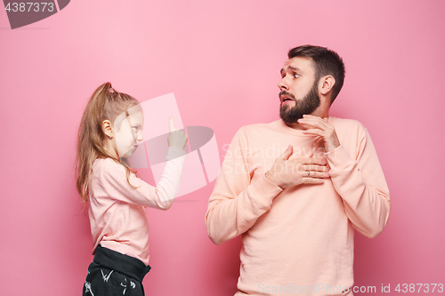 Image of Young father with his baby daughter. The kid in preschool age pointing with finger