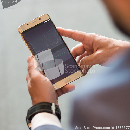 Image of Close up of businessman using mobile smart phone.