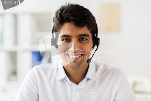 Image of businessman in headset at office