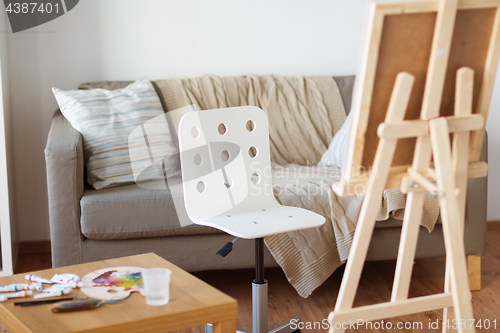 Image of wooden easel and chair at home room or art studio