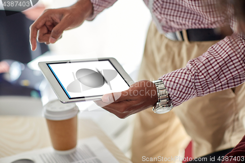 Image of designer with image on tablet pc screen at office