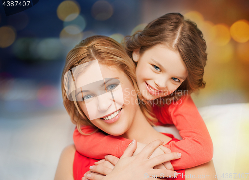 Image of happy mother and daughter hugging