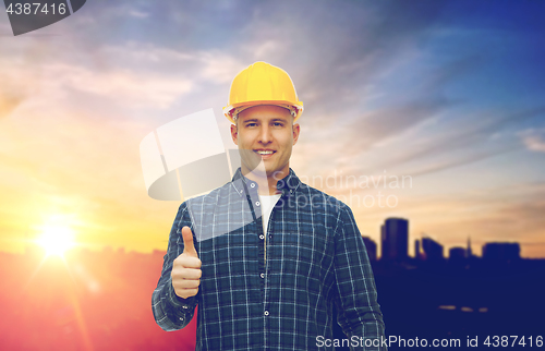 Image of male builder in yellow hard hat showing thumbs up