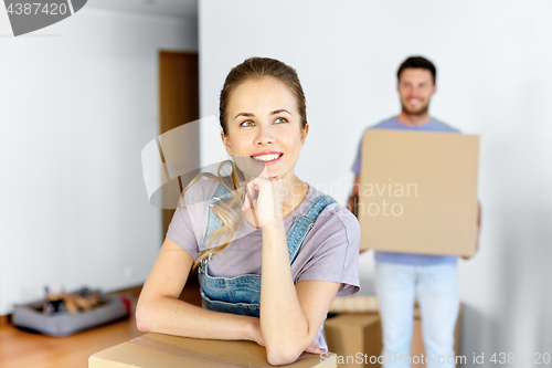 Image of happy couple with boxes moving to new home