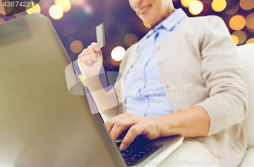 Image of senior woman with laptop and credit card