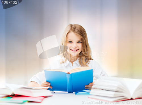 Image of happy smiling student girl reading book