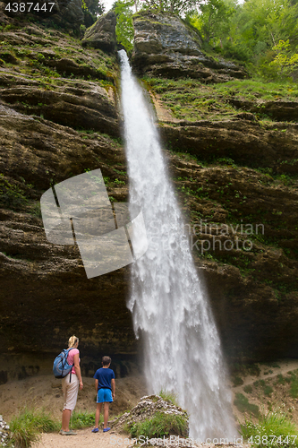 Image of Active tourists looking at Pericnik waterfall in Vrata Valley in Triglav National Park in Julian Alps, Slovenia.