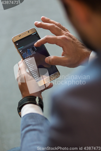 Image of Close up of businessman using mobile smart phone.