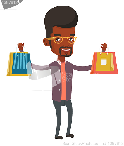 Image of Happy man holding shopping bags.