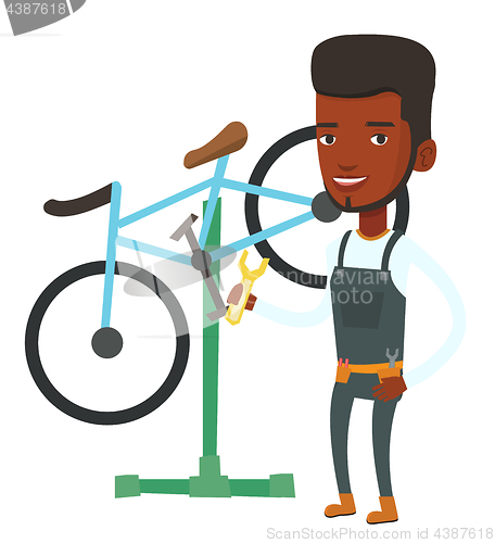 Image of African bicycle mechanic working in repair shop.