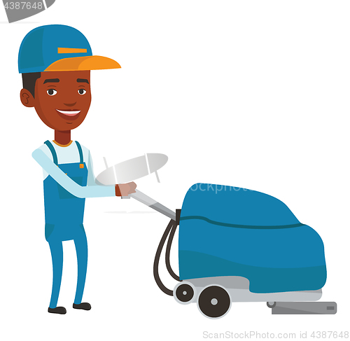 Image of African worker cleaning store floor with machine.