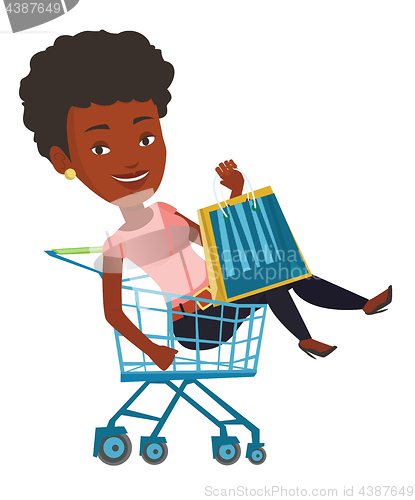 Image of Happy woman riding by shopping trolley.